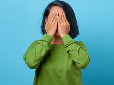 Personal Grievance. Auckland, Wellington, Christchurch. Woman with hands over her face.