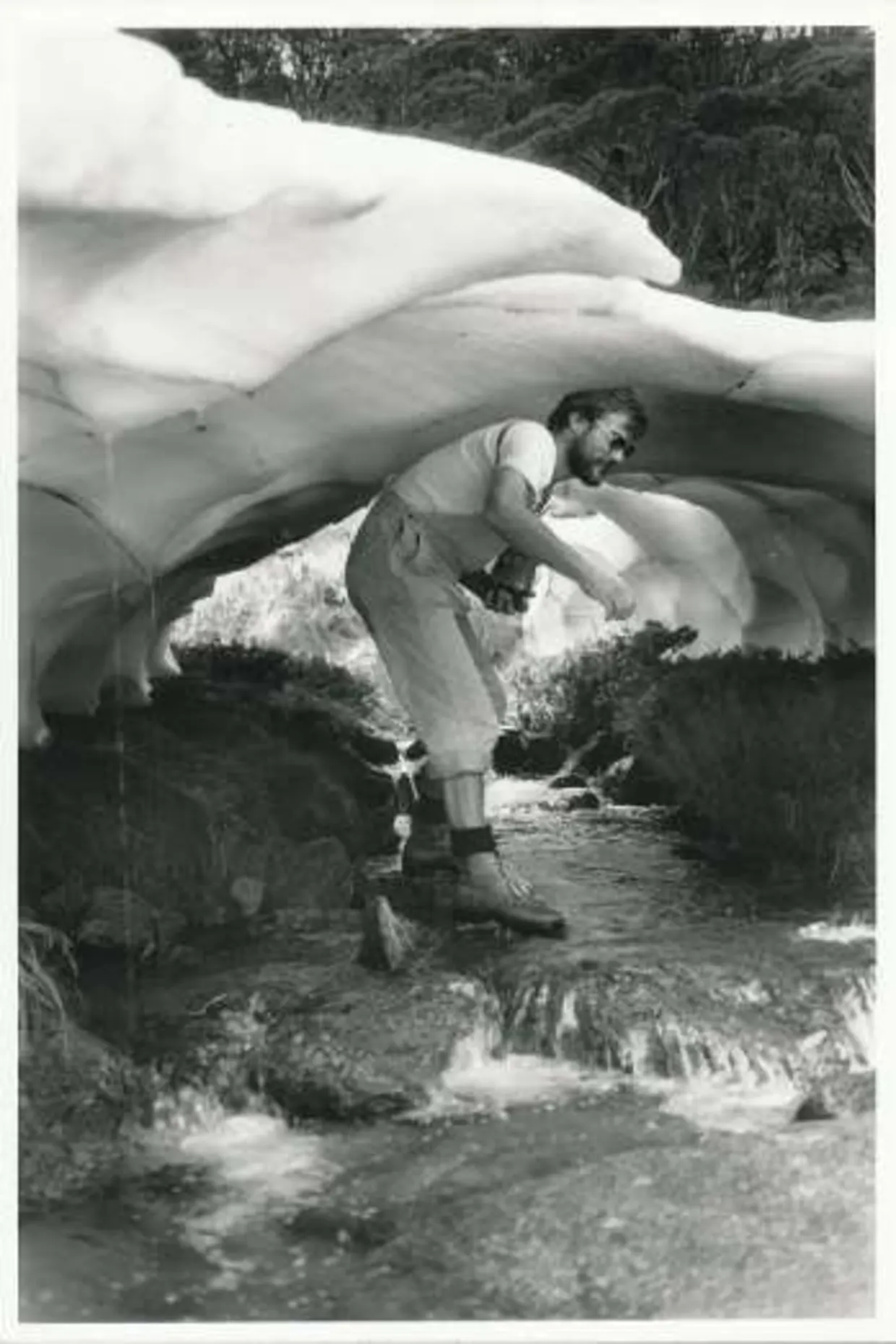 Klaus inside a snow tunnel on a tributary to Guthega River during a walk up Rolling Ground