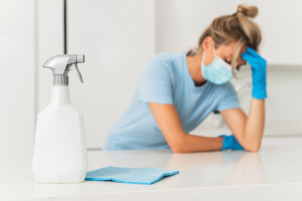 Woman feeling unwell during house cleaning, indicating possible allergies triggered by fragrances or dust.