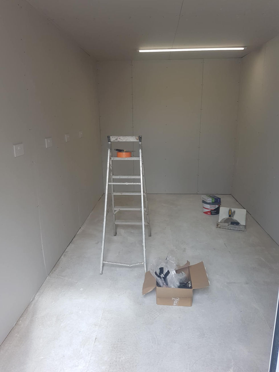 Empty room, ladder, paint supplies