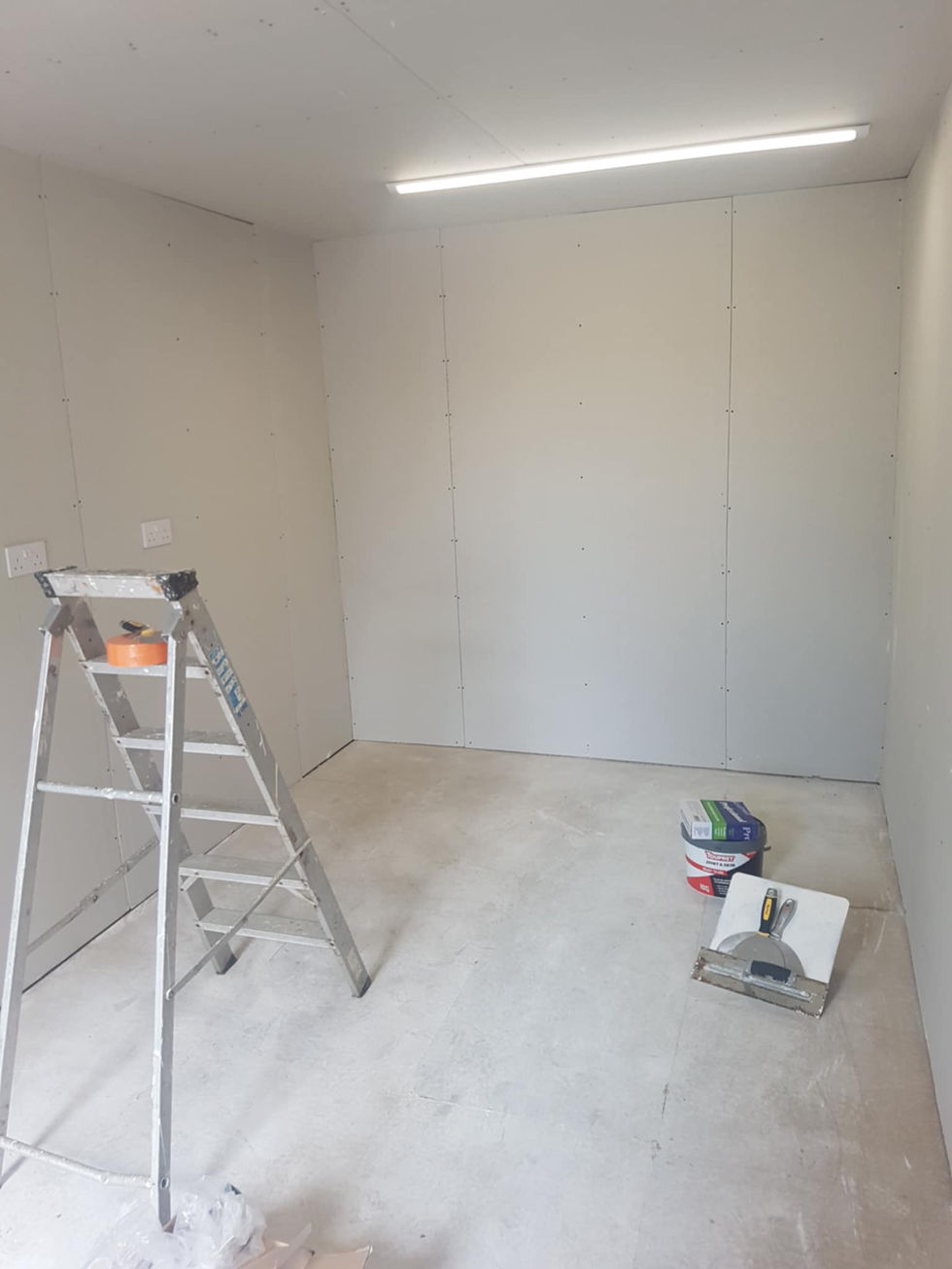 Bare plasterboard walls in a residential property prior to starting ames taping and jointing in Errol, Perth