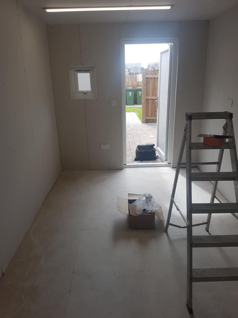 Empty room, open door, stepladder, boxes