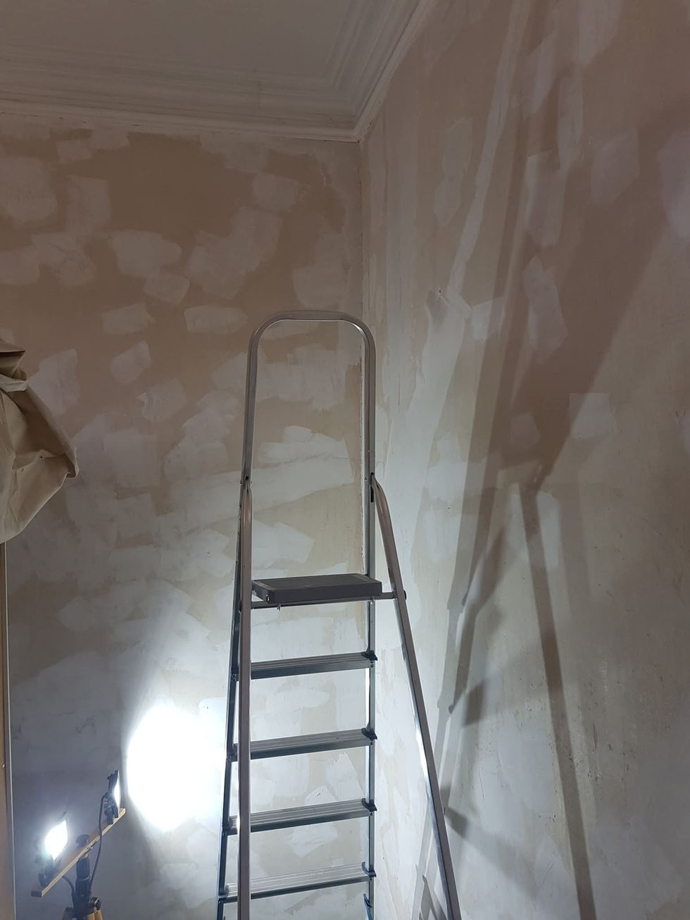 a ladder is leaning against a wall in a room