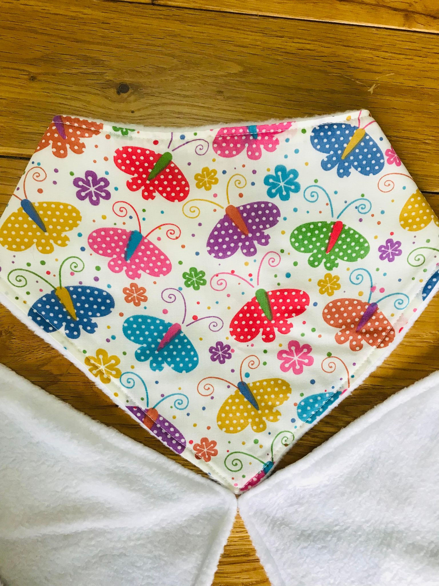 Cream with multicoloured butterfly. Dignity bib. Dribble bib. Bandana Style