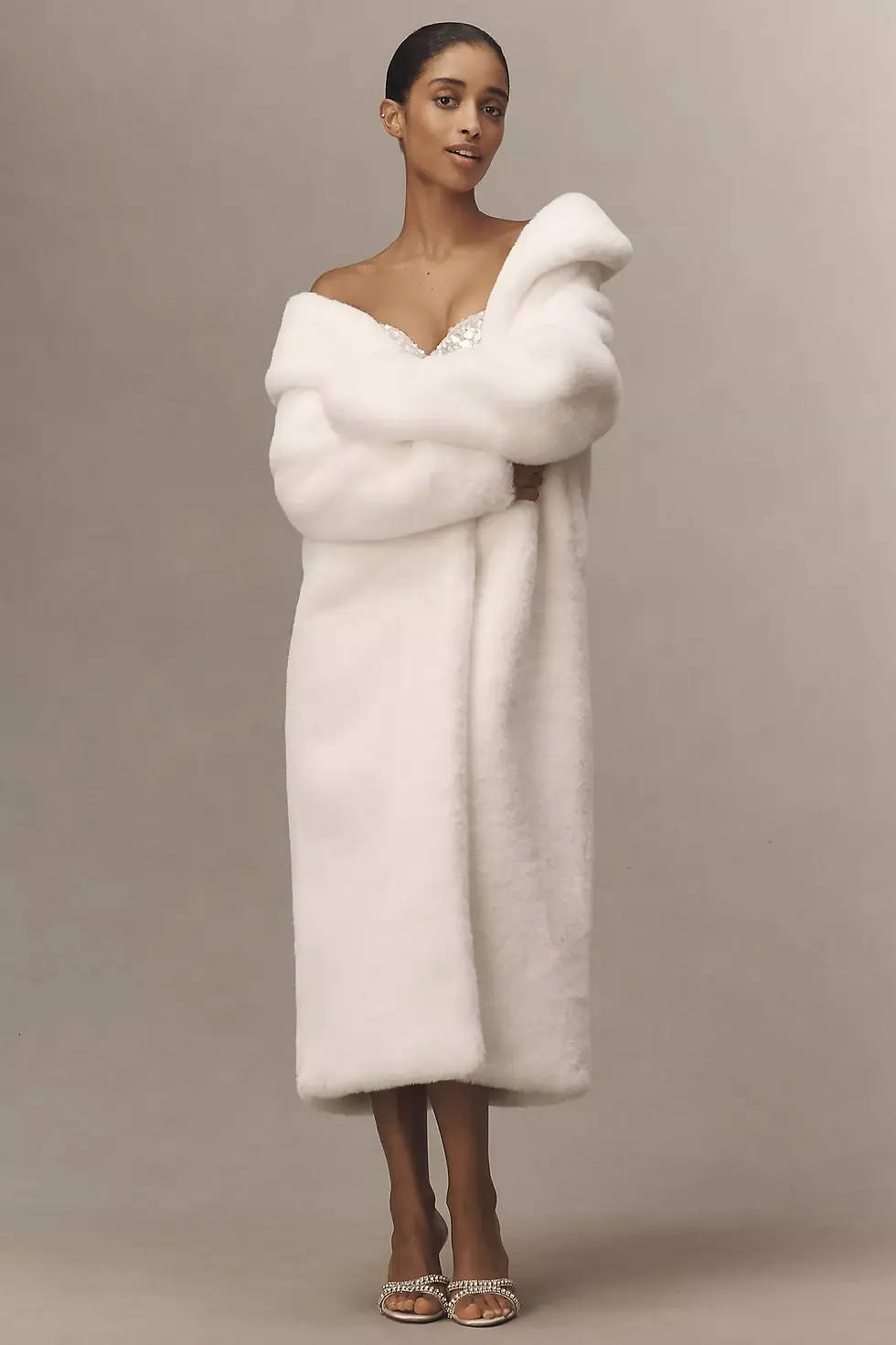 Long ivory faux-fur bridal coat for a fall or winter wedding event