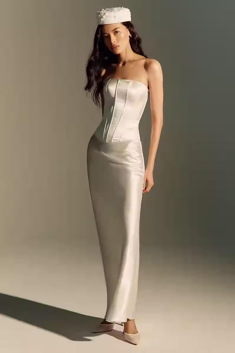 Ivory satin set with a strapless corset top and matching fitted long skirt for a rehearsal dinner.