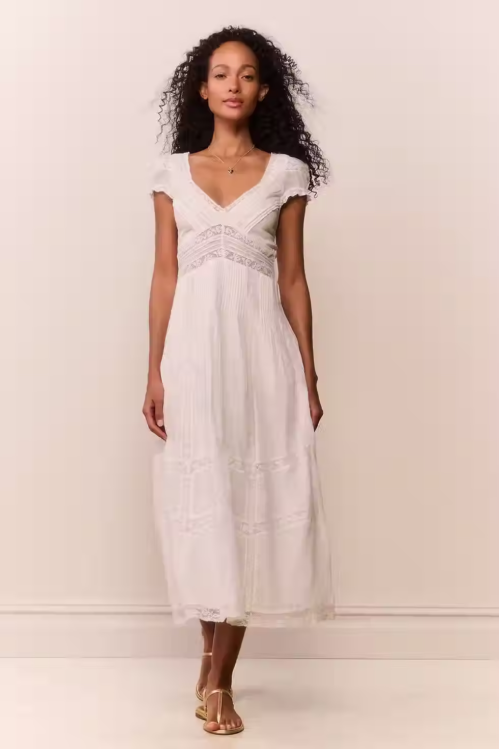 White midi dress with a feminine silhouette and elevated detailing for a honeymoon dinner or daytime look.