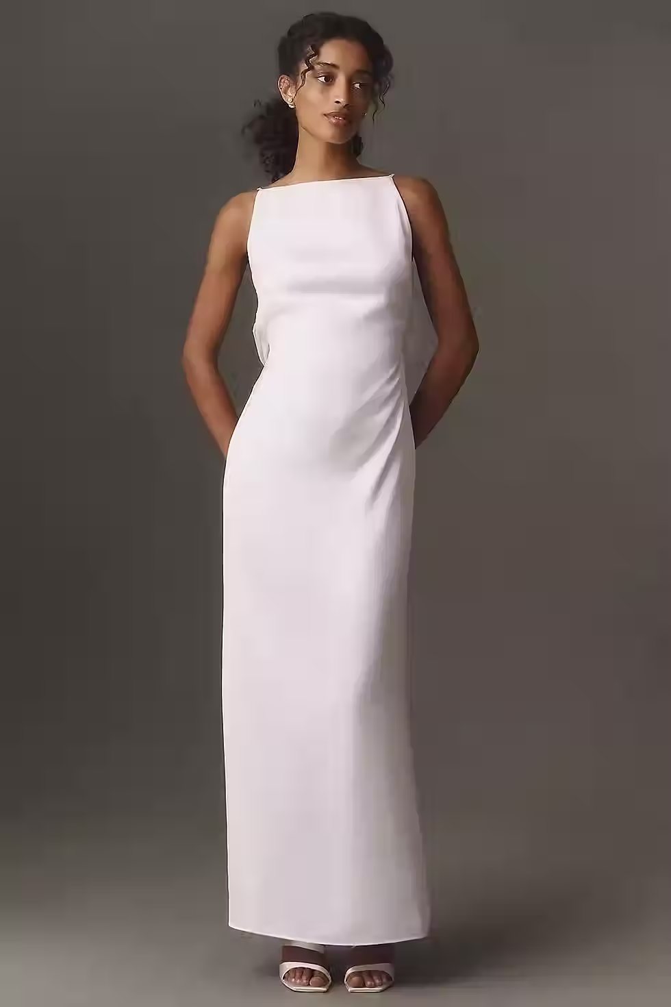 White sleeveless column maxi dress with a bateau neckline and sleek fitted silhouette for a rehearsal dinner