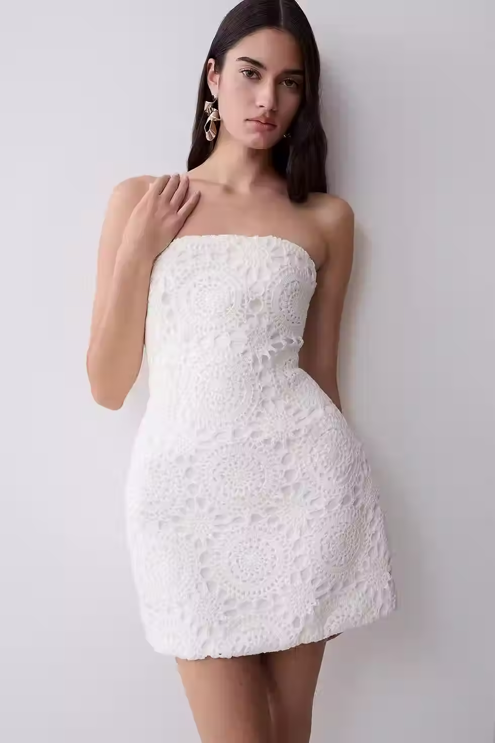 White strapless crochet mini dress with a fitted bodice and subtle A-line shape for a bachelorette party