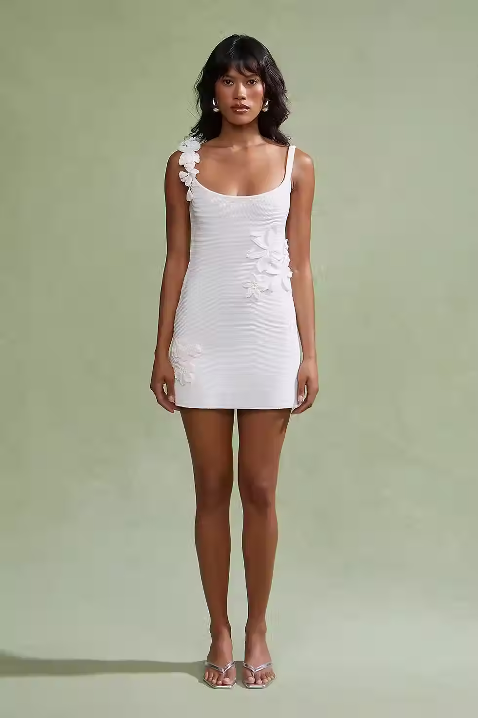White scoop-neck knit mini dress with dimensional floral appliqués on the straps and bodice for a wedding after-party
