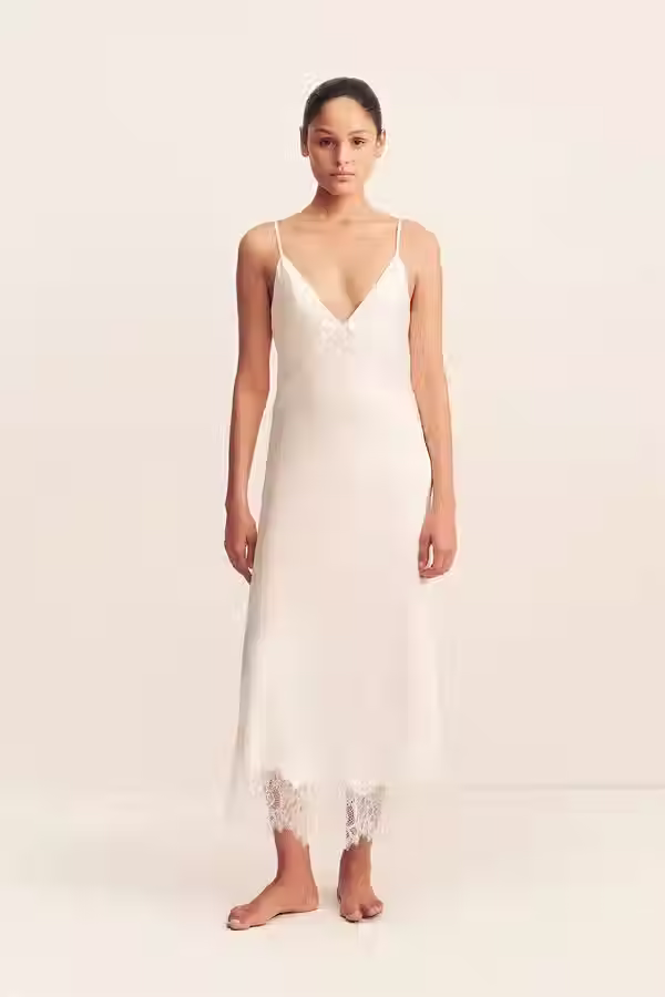 Ivory lace slip midi dress with spaghetti straps and a fitted silhouette for a rehearsal dinner or bridal event