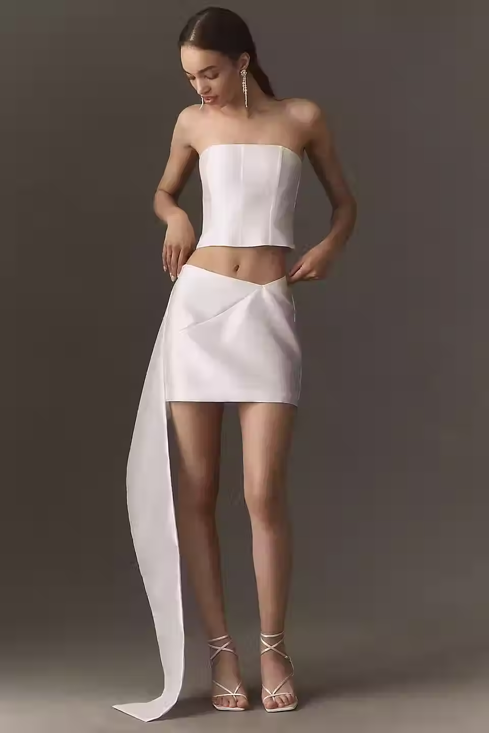 Ivory strapless corset top and mini skirt set with a floor-length side sash for a wedding after-party