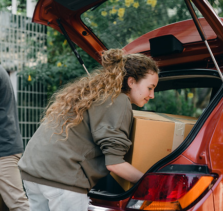 diverse-couple-taking-things-out-of-car-