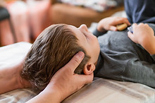 Real osteopath does physiological skull therapy for a child Osteopathy Treatment.jpg