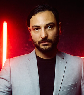 CEO wearing a suit with red lights behind him