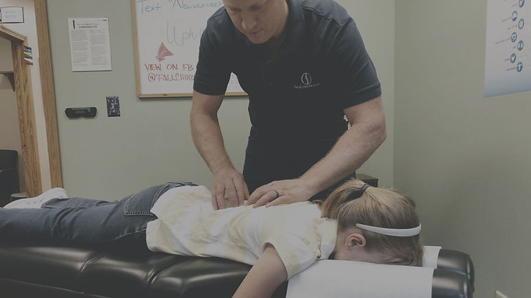 Bryan Fall gives spinal care to young lady.
