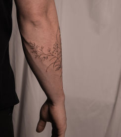 Delicate fine line botanical tattoo wrapping the forearm, Kvitka Tattoo Studio Chicago