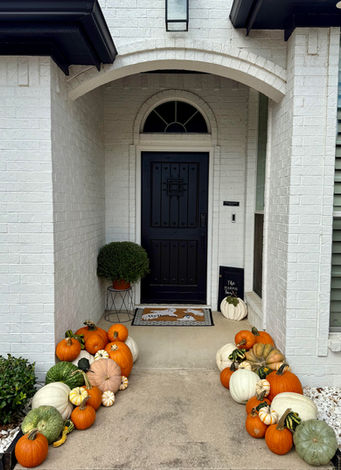Designer fall porch installation with colorful pumpkins in Keller, TX.
