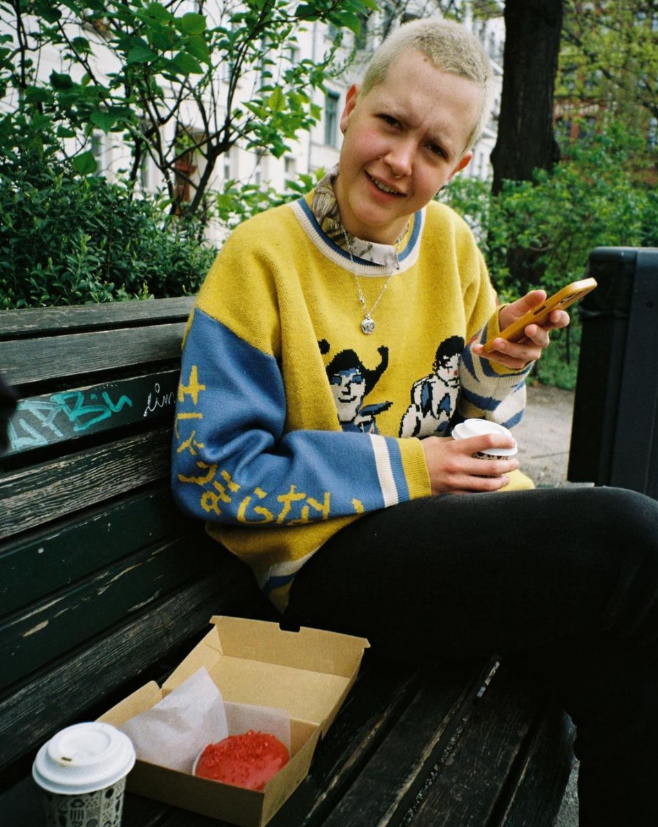 Perso sitting on a bench looking at the camera