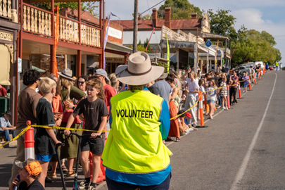 Volunteer parade marshal looking up the hill at Golden Horseshoes Festival