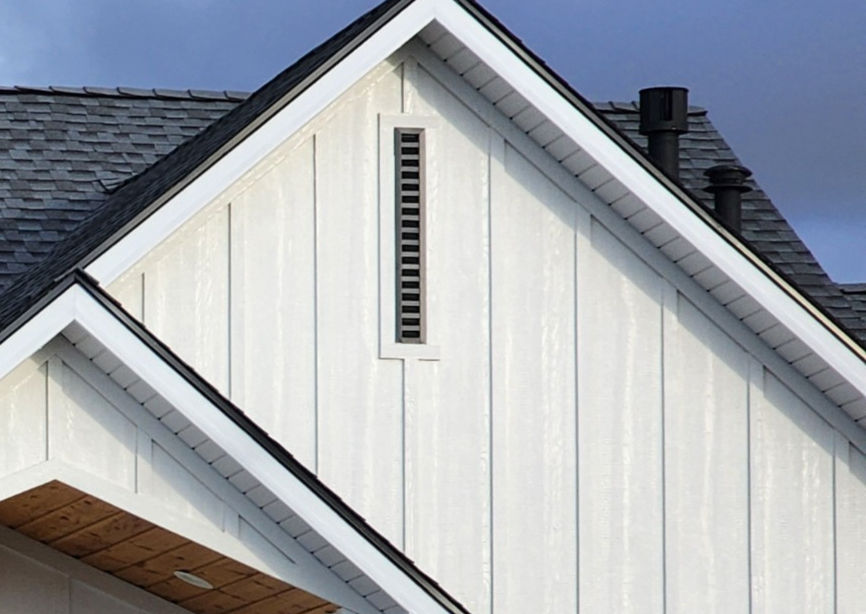 Close-up view of a wooden gable vent installed on a house exterior