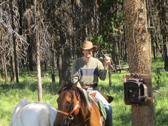Shane Greet on horseback in a forest
