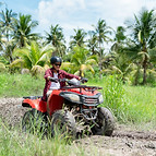 Quad bike in dust cloud, sand quarry on background. ATV Rider in the action..jpg