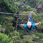 young man zooming thru a cloud forest on a zip line adventure in Monteverde Costa Rica.jpg