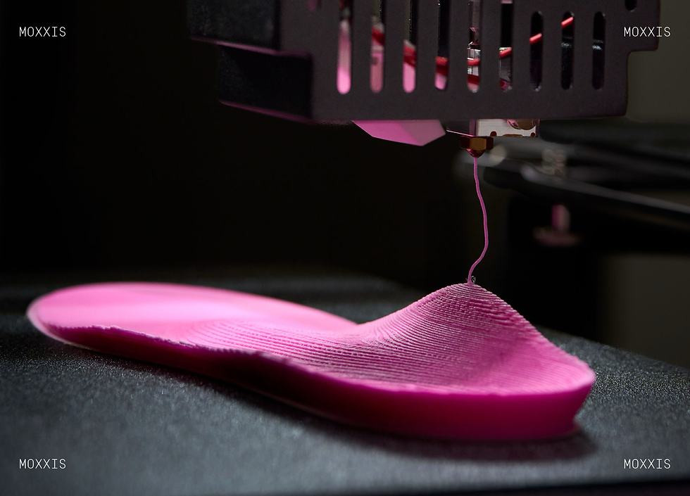 3D printer extrudes pink shoe sole on dark bed, with MOXXIS text in corners, sleek high-tech close-up