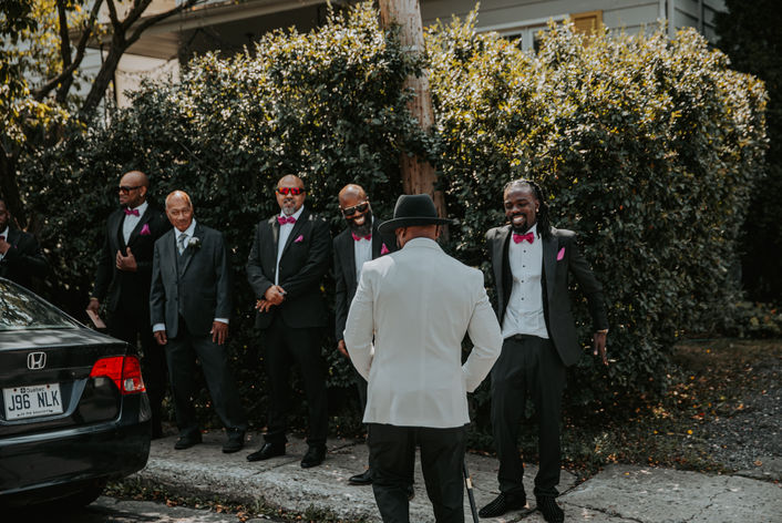 Groomsmen laughing and preparing before the wedding.