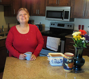 A woman proudly living independently in a supported apartment.