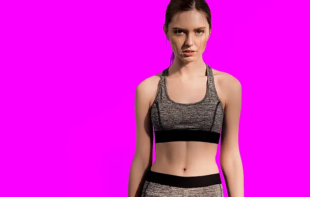 Female Sport Model with hair tied back modeling Medium Grey Sport Workout Bra Top.webp