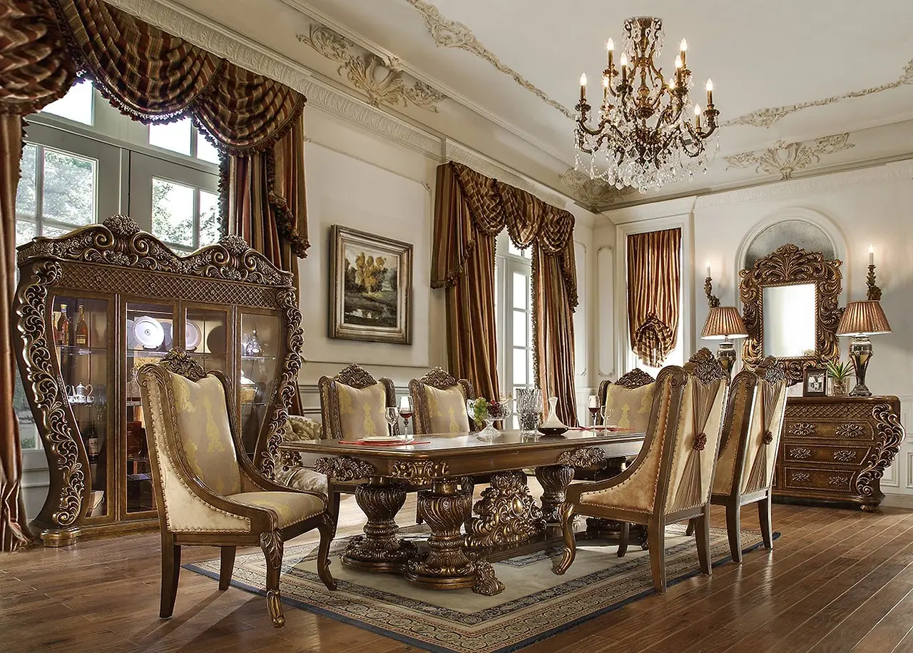 Luxury Mediterranean Dining Room with mediterranean furniture includes mediterranean brown walnut wood dining table with 6 mediterranean brown walnut wood and cream fabric chairs over a floor mediterranean cream and brown flat rug; all walls and ceiling are painted light cream and decorated with mediterranean bass relief. The floor is walnut wood plank tiles. The left wall has 2 big 3 partition windows covered with window treatment mediterranean brown colors palette fabric. Between the left wall 2 big windows there is a beautiful wall hung mediterranean framed art paint. The left wall farther left window on front has a mediterranean brown walnut wood tall china four glass doors cabinetry. The right wall has a mediterranean brown walnut wood drawers console with 2 mediterranean lamps on top divided by a mediterranean big framed mirrow. The mediterranean dining table has a ceiling centered mediterranean ten bulbs chandelier.