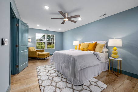 Modern primary bedroom suite with sophisticated lighting