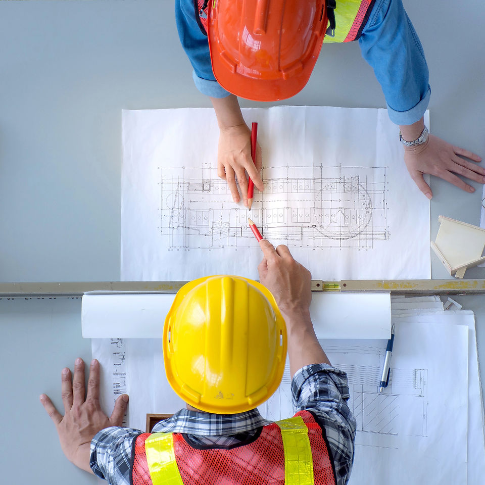 Image of Building Inspectors reviewing Blueprints at Site.
