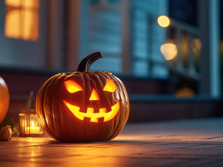 Jack O' Lantern and candles lit up at night on front porch of a home