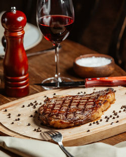 neat-steak-wooden-stand-with-glass-red-wine