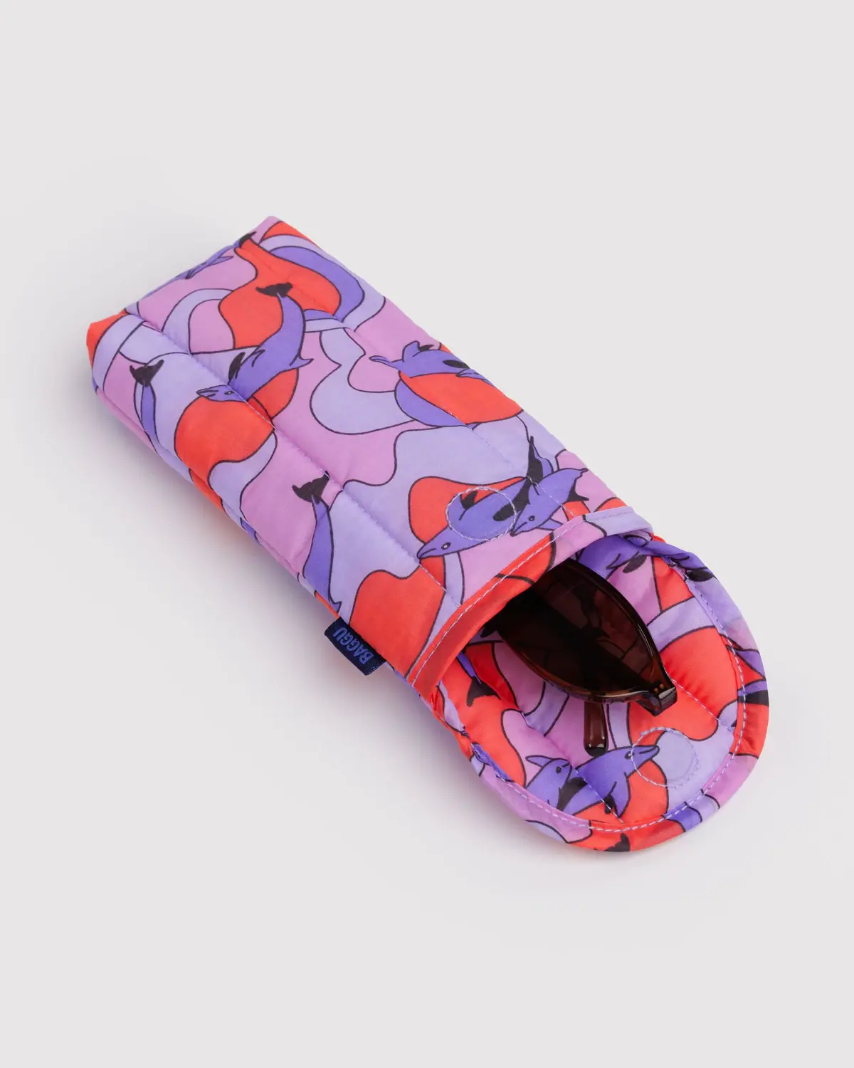 BAGGU Puffy Glasses Sleeve Dolphins geöffnet und mit Sonnenbrille drin