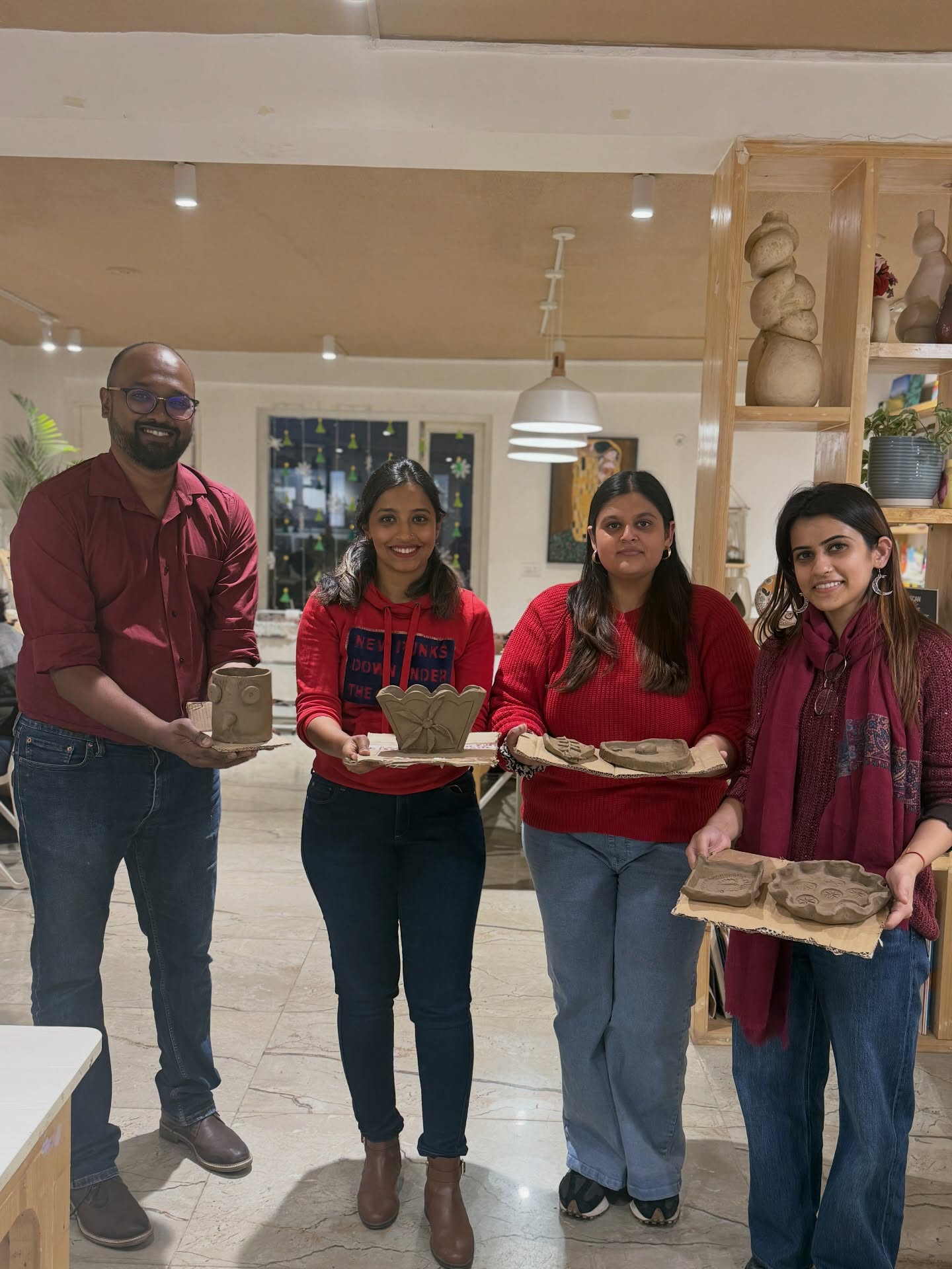Guests with finished clay bowls at Alive Studio