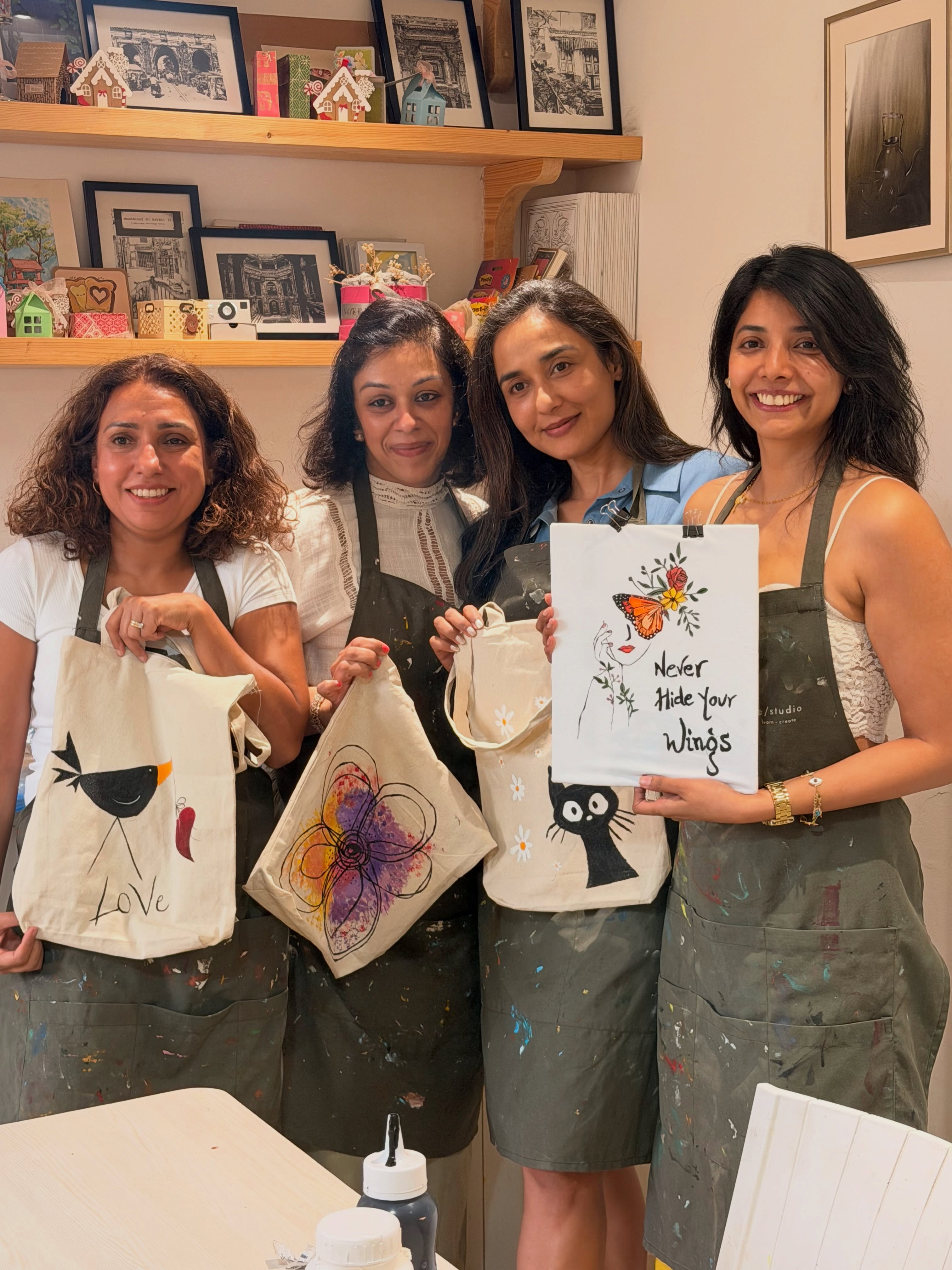 A team holding finished painted tote bags