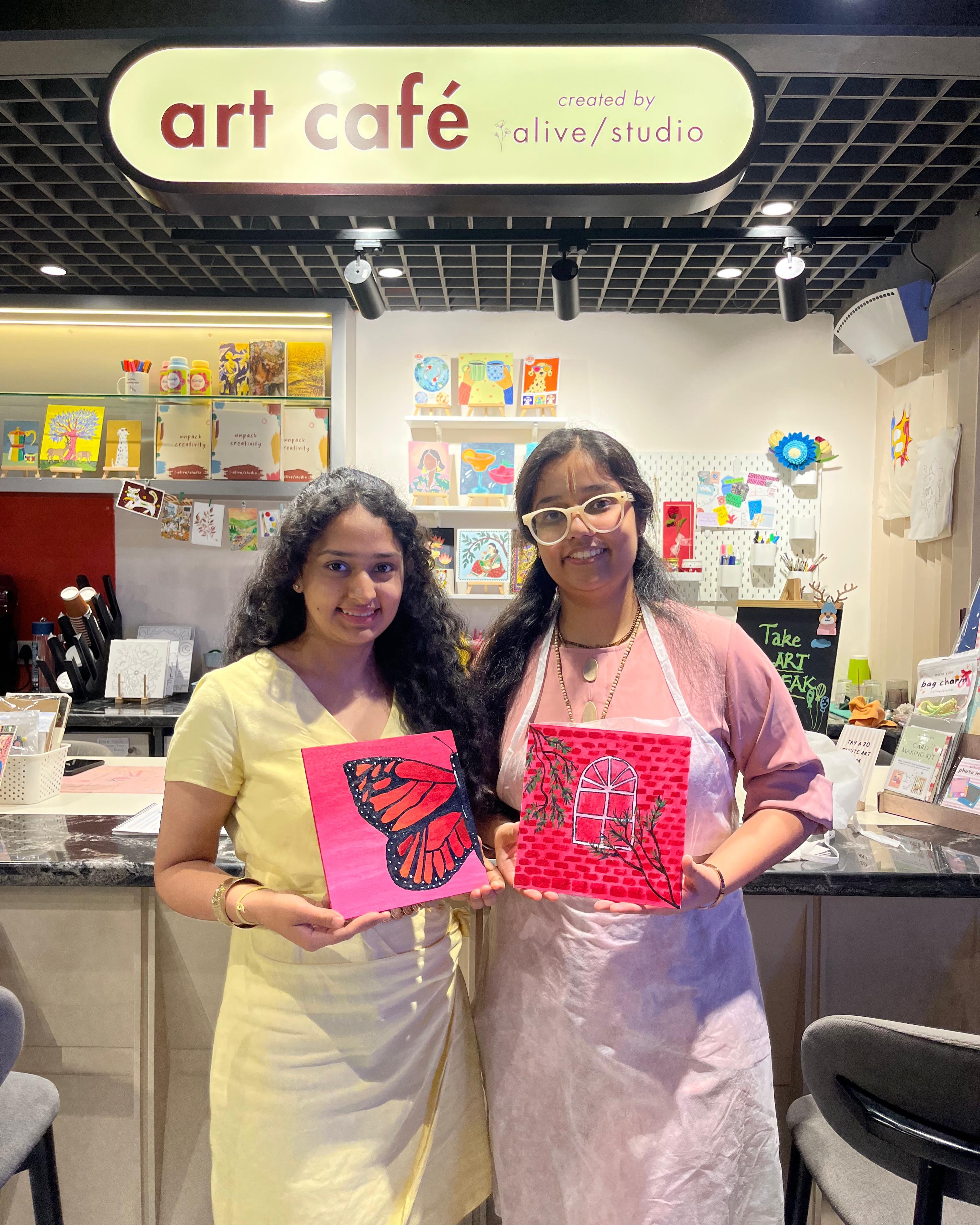 A guest in an apron with her finished artwork