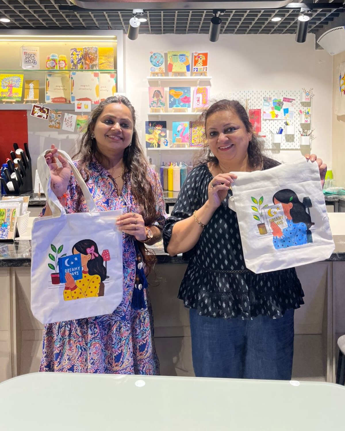Friends with painted tote bags at Delhi Art Cafe