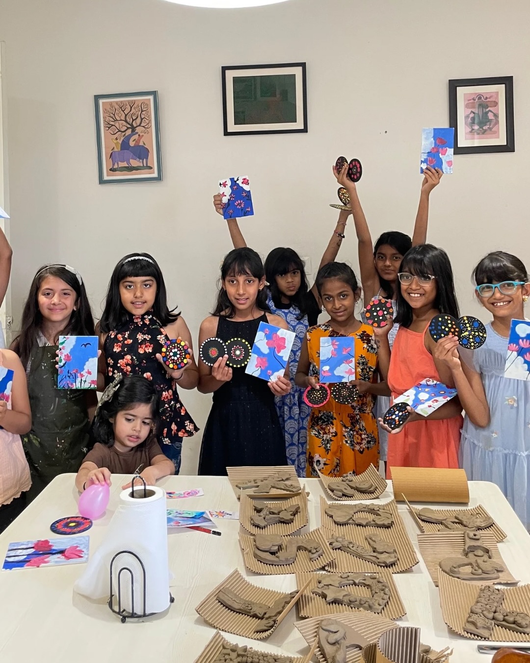 Children holding finished art at a birthday celebration