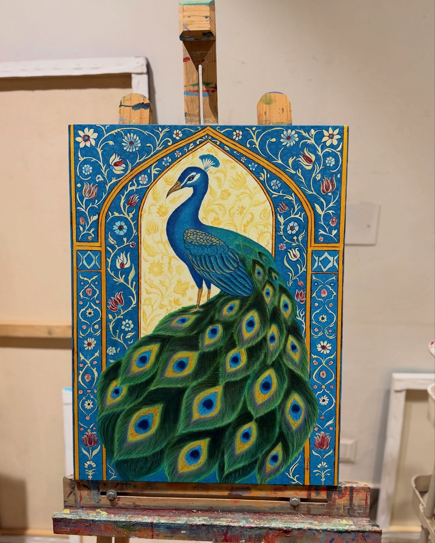 An intricate peacock panel painting at Alive Studio