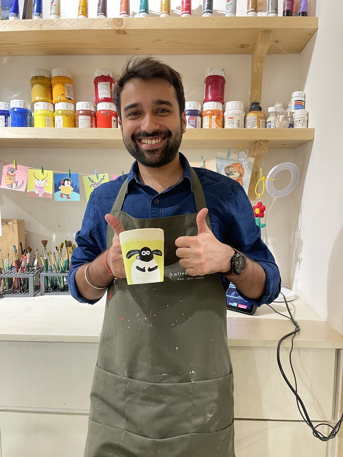 Holding up a mug painted at a team session