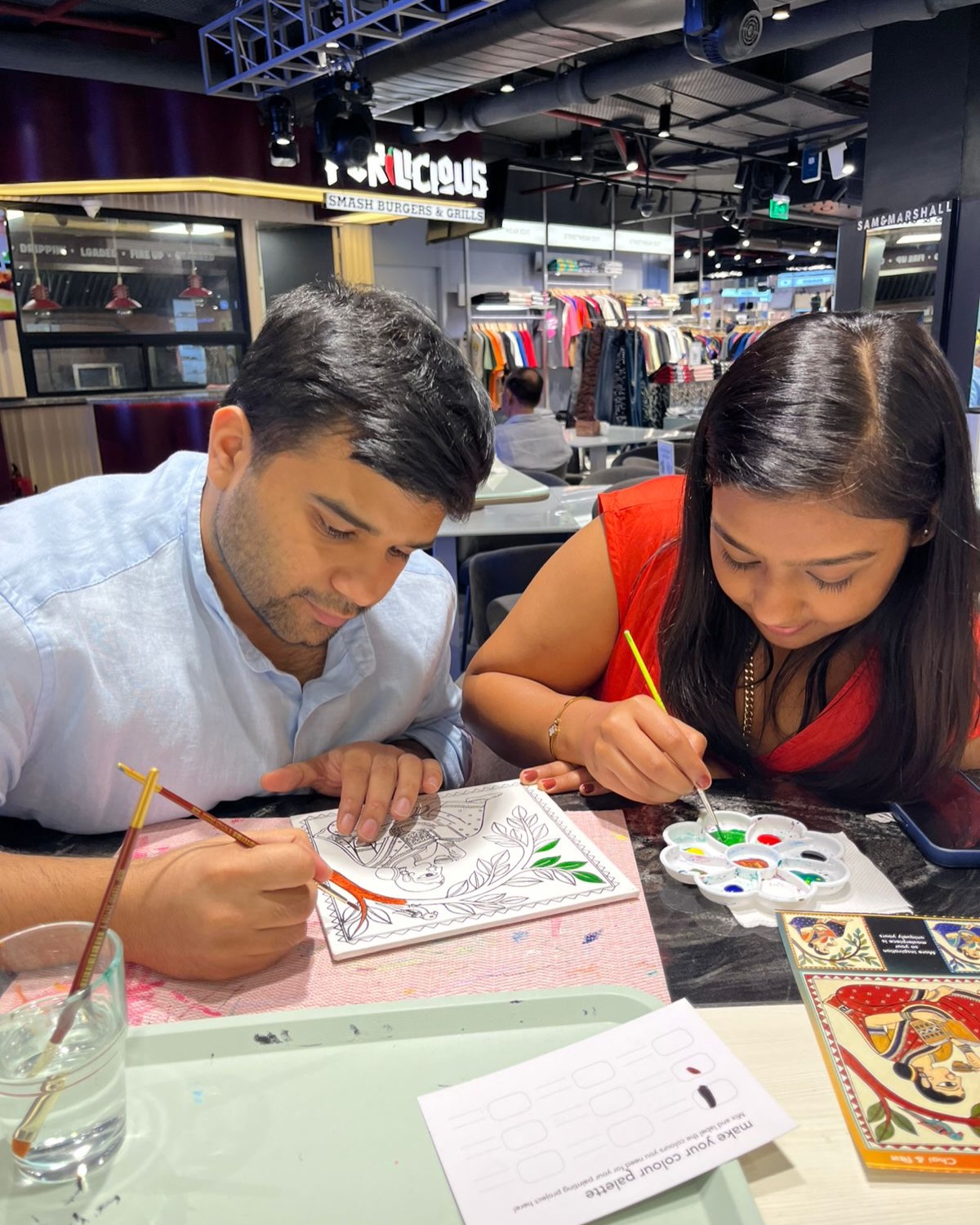 A couple making art together at Delhi Art Cafe