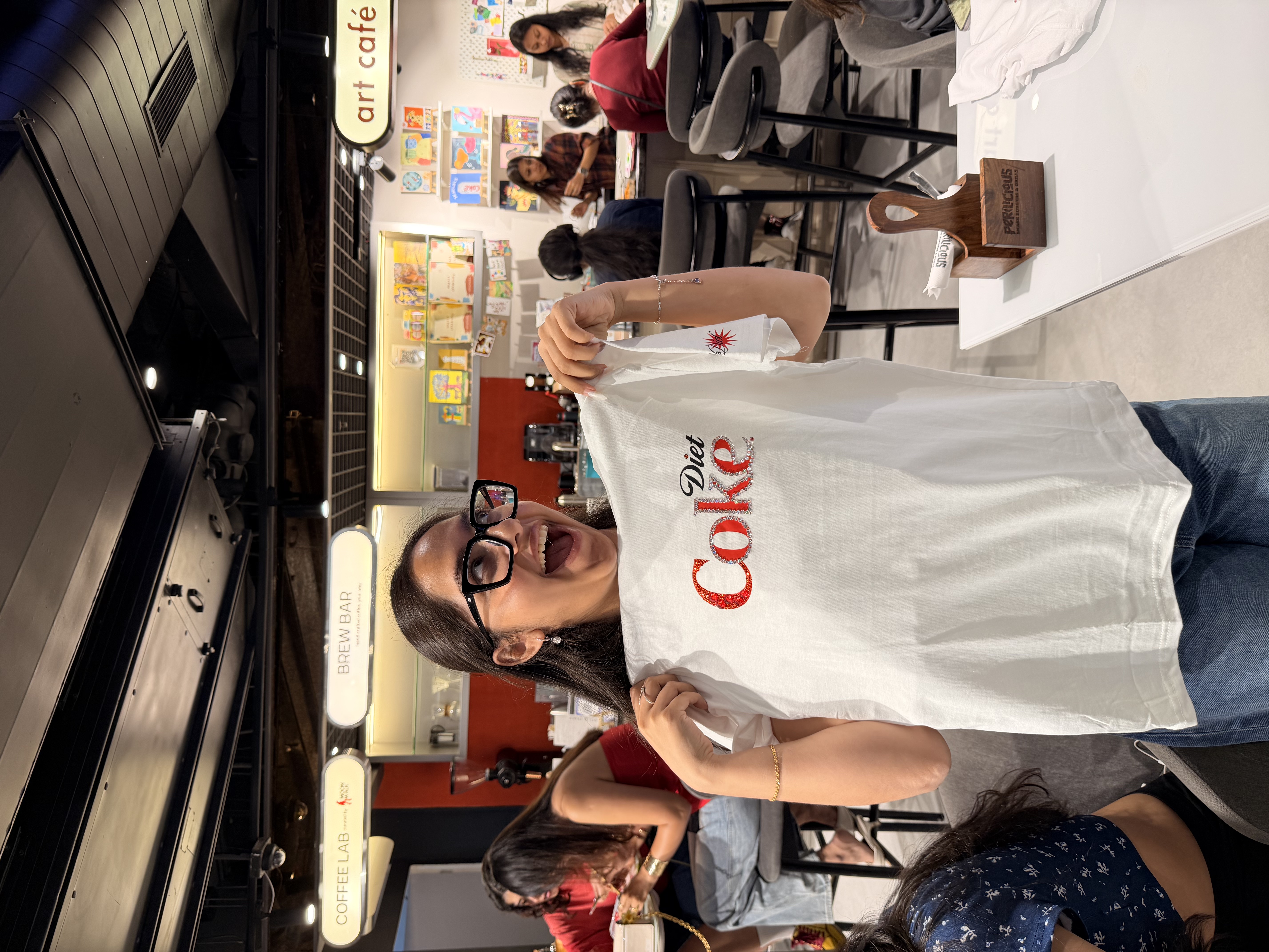A guest with a hand-painted Diet Coke tee at the Delhi Art Cafe