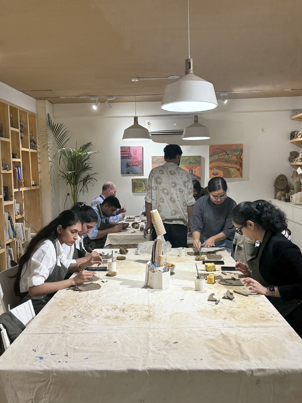 A team at a clay workshop around a long table