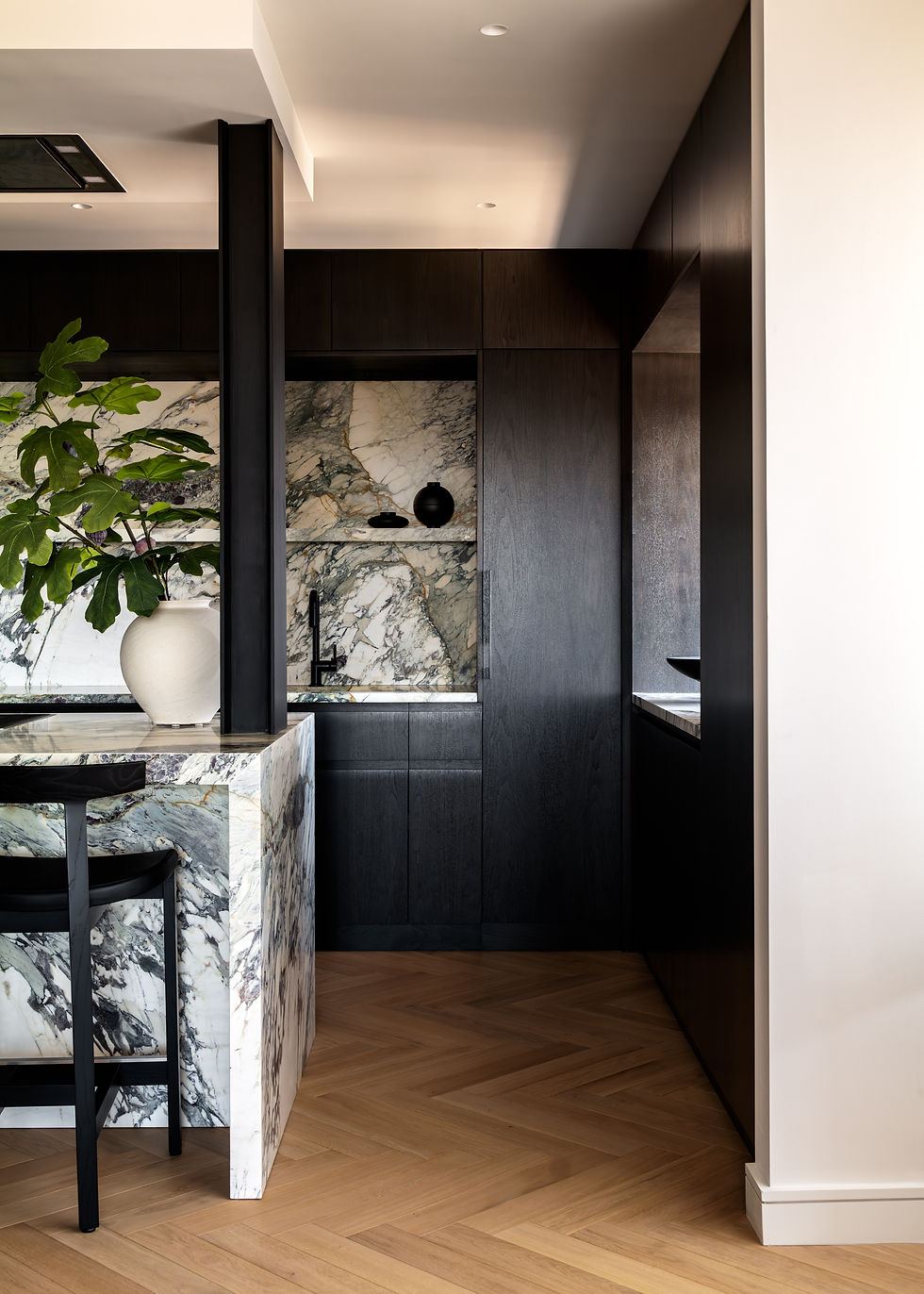 Studio Ocra interior design and apartment renovation dark kitchen cabinet and marble