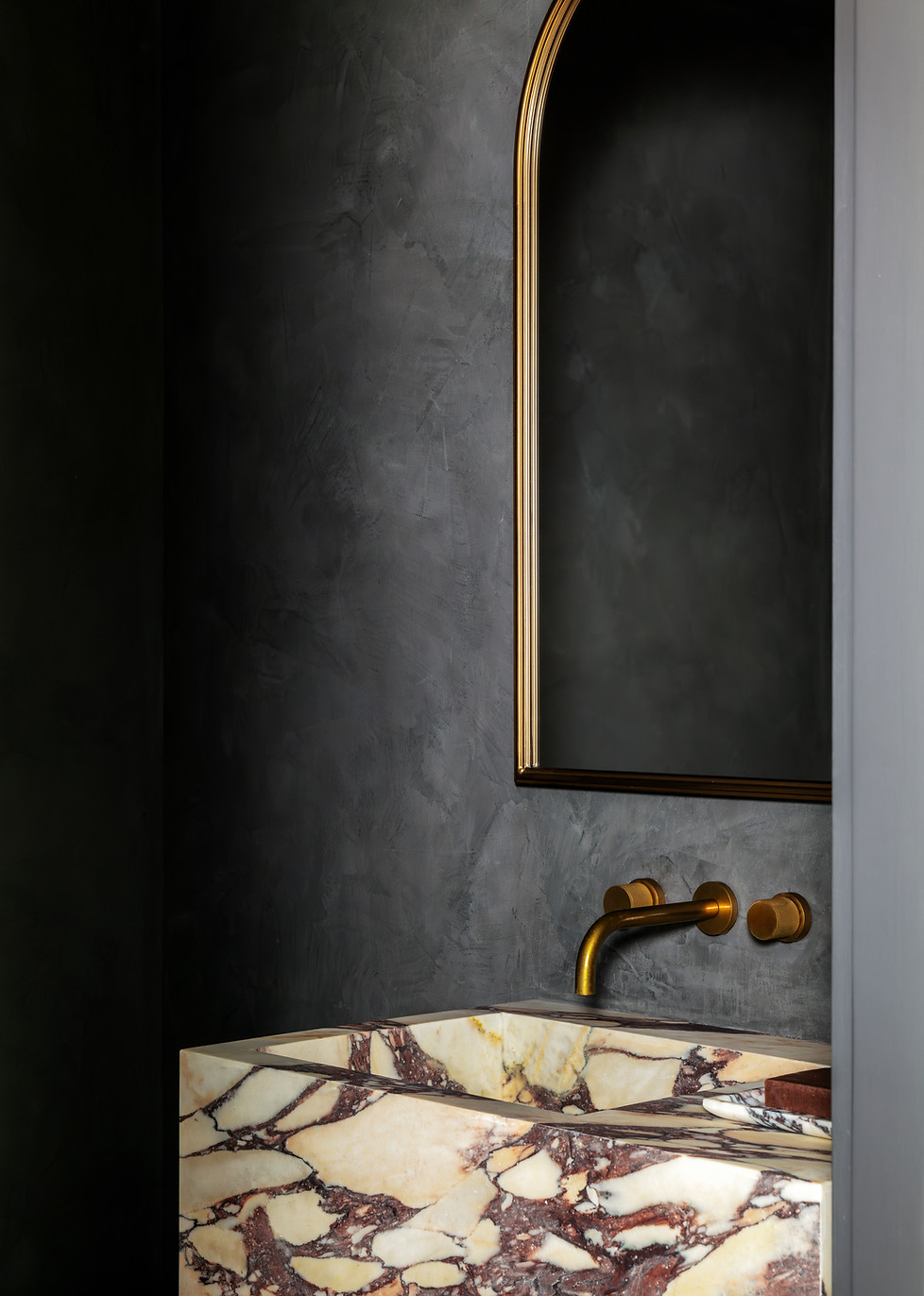 Studio Ocra interior design plaster wall finish in powder room